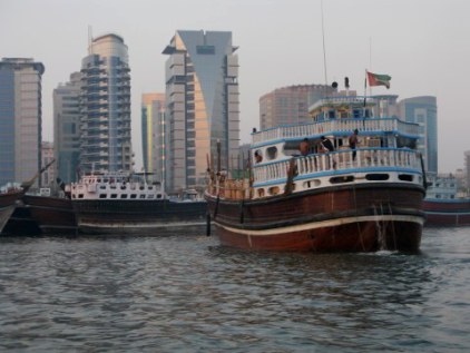 Traditional wooden trading dhow pumping bilge - Dubai Creek Traditional wooden trading dhow pumping bilge - Dubai Creek