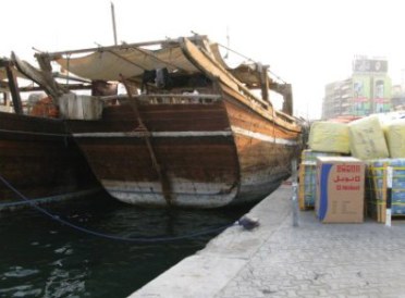 Wooden dhow traders with goods on dock Dubai Creek Wooden dhow traders with goods on dock Dubai Creek