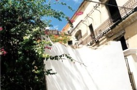 Former gerat house behind crumbling wall in Havana