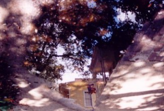 Verandahs reflected in puddle in the French Quarter New Orleans