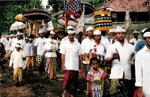 Ceremonial procession with cymbals at the Village of White Herons in Bali