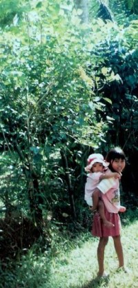 Girl carrying baby in Bali