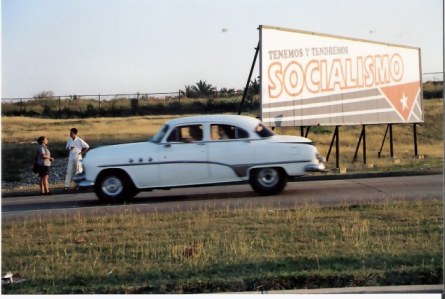 Havana-classic-car-by-revolution-sign 