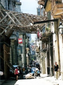 Timber bracing across street to hold up house wall in Havana