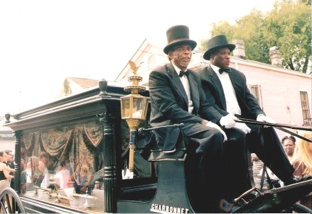 Horse-drawn hearse bearing coffin Jazz Funeral New Orleans