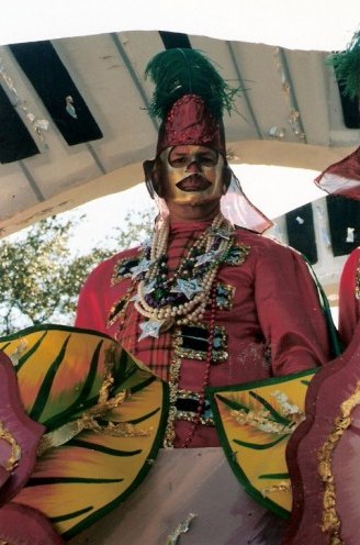 Masked Krewe member on New Orleans Mardi Gras float
