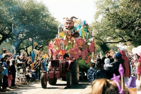 Outstretched hands and parade float at New Orleans Mardi Gras