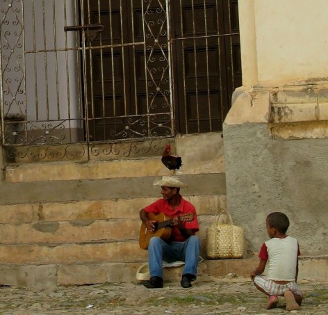 Rooster on hat of  musician Trinidad de Cuba