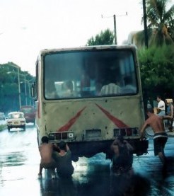 Fourth boy joining the street water-skiing in Havana