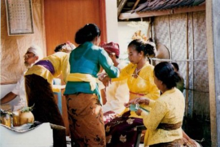 Tying bride and groom with cords at Bali village wedding